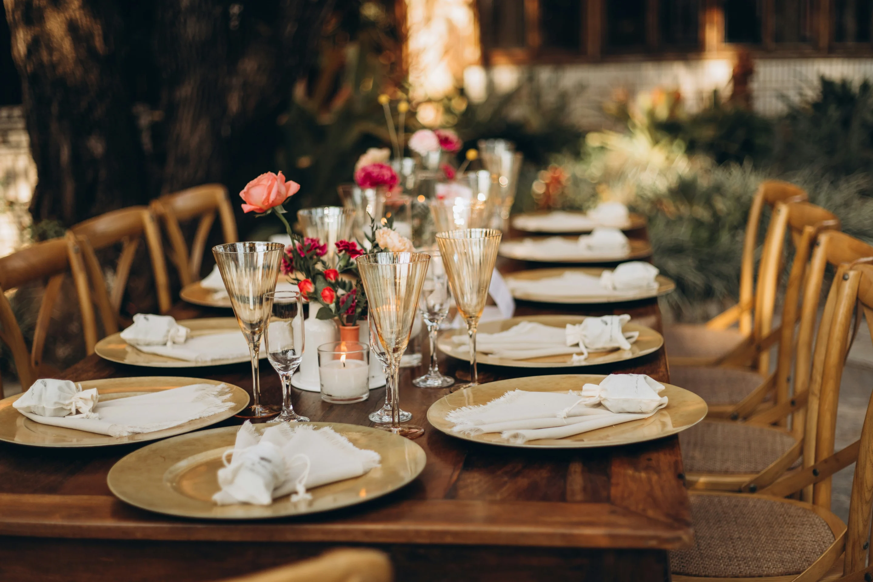 A beautifully set table for dinner with plates, cutlery and glasses ready for guests.