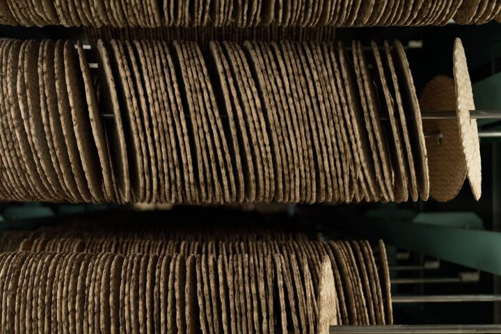 Stacks of round flatbread discs lined up vertically on metal rods.