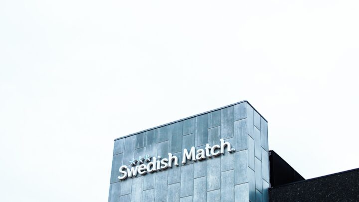 Building facade with "Swedish Match" logo against a clear sky.