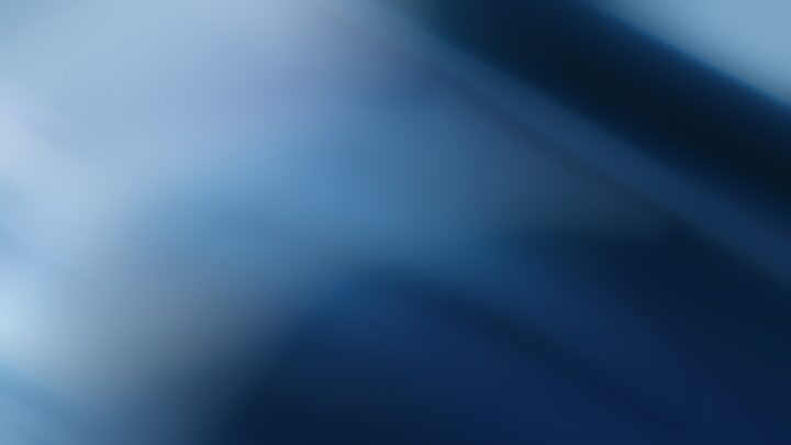 Abstract blurred blue gradient background with soft light and smooth dark to light transitions.