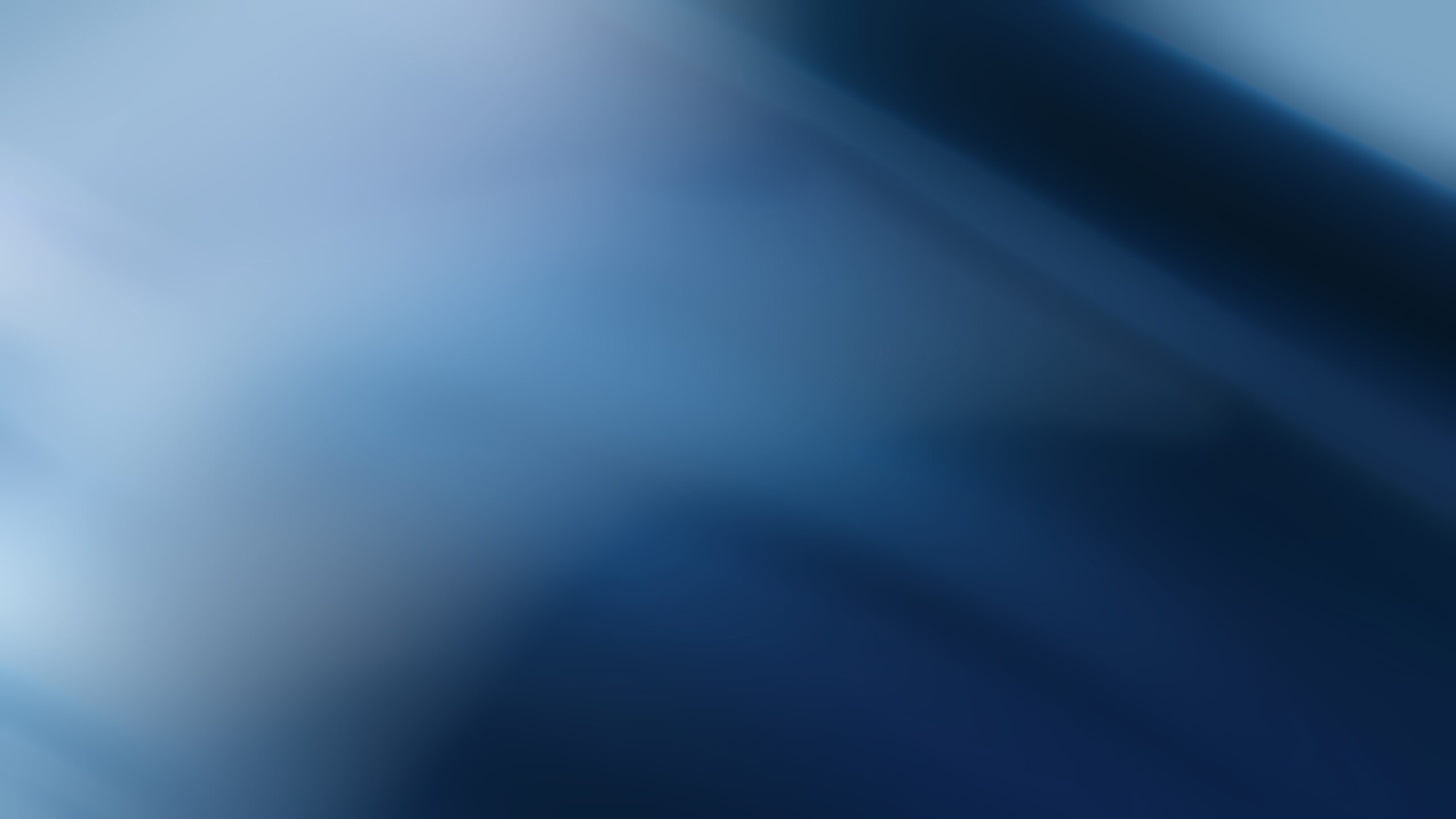 Abstract blurred blue gradient background with soft light and smooth dark to light transitions.
